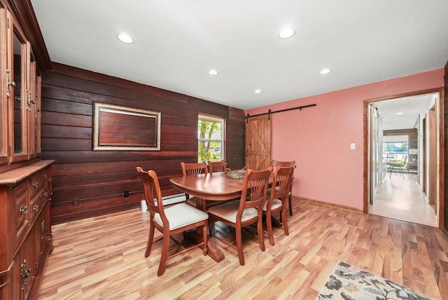 dining space with light wood-style floors, a barn door, recessed lighting, and baseboard heating