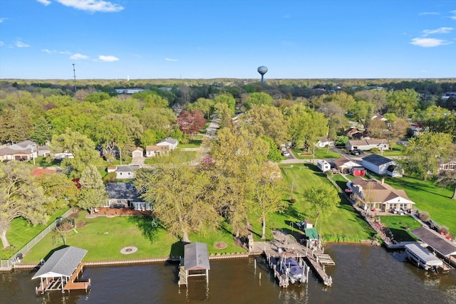 aerial view of property and surrounding area with a large body of water and nearby suburban area