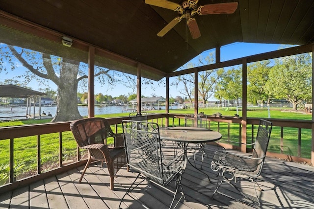sunroom / solarium featuring a water view, ceiling fan, and lofted ceiling