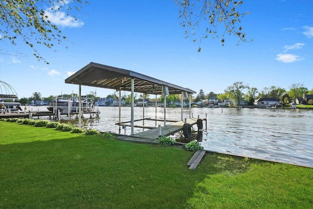 dock area featuring boat lift, a lawn, and a water view