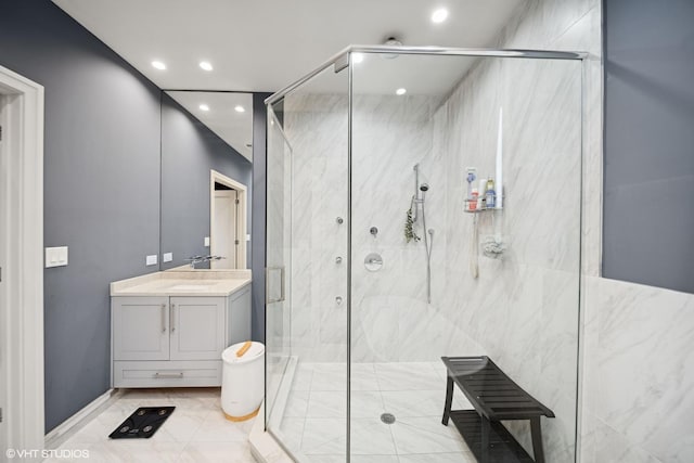 bathroom featuring recessed lighting, vanity, a marble finish shower, and tile patterned floors