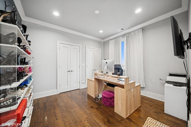 office space with crown molding, visible vents, baseboards, and dark wood-type flooring