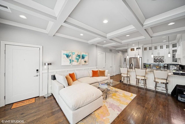 living area with beamed ceiling, dark wood-style flooring, and coffered ceiling