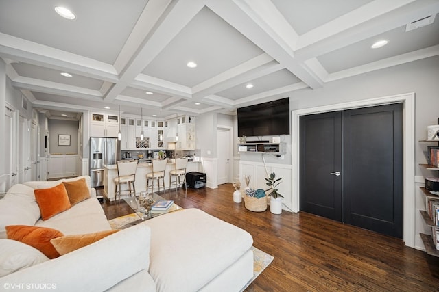 living area with beam ceiling, recessed lighting, dark wood-type flooring, wainscoting, and coffered ceiling