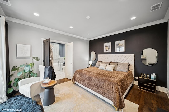 bedroom with baseboards, visible vents, wood finished floors, and ornamental molding