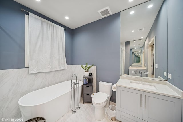 full bath with toilet, a soaking tub, visible vents, and vanity