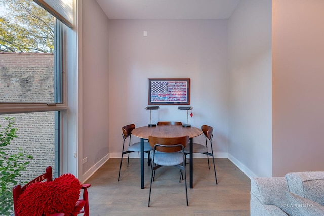 office area with baseboards and wood finished floors