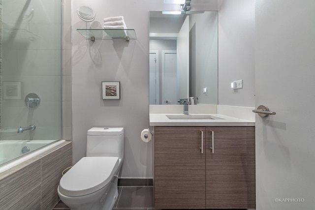 full bath featuring tiled shower / bath combo, vanity, and toilet