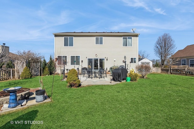 rear view of property with a fenced backyard, a patio, and a yard