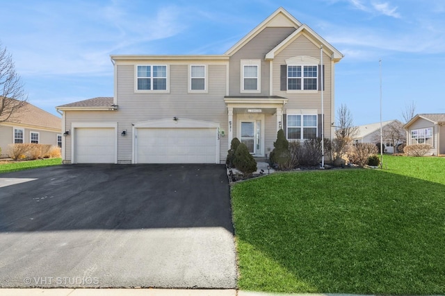 traditional-style home with a front lawn, an attached garage, and driveway