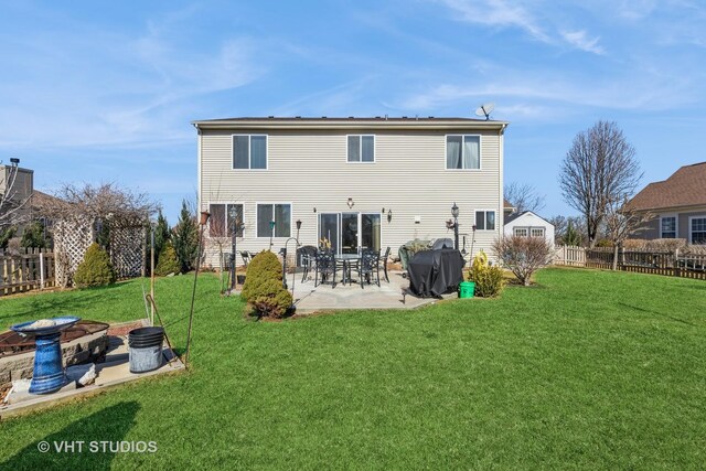 rear view of house with a patio and a lawn