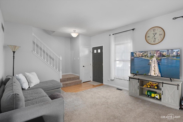 living room featuring stairs, carpet, baseboards, and visible vents