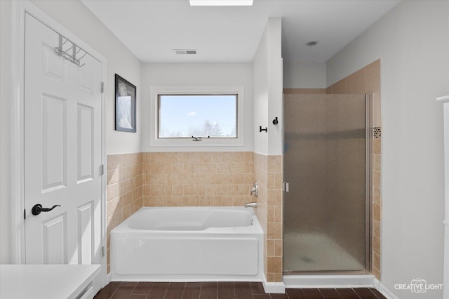 full bathroom with a bath, visible vents, and a stall shower