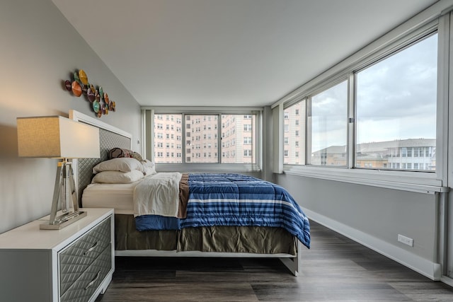 bedroom featuring baseboards and dark wood-style floors