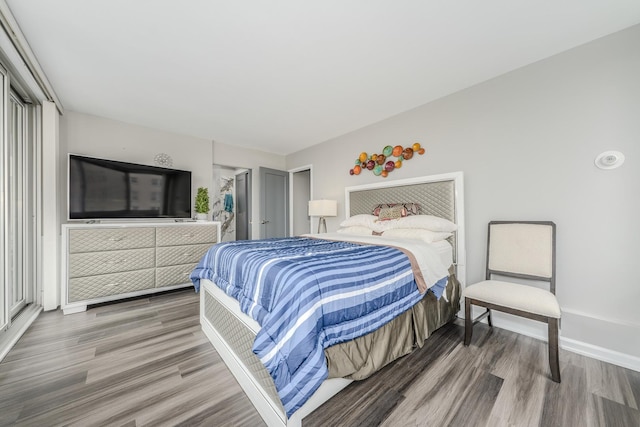 bedroom featuring baseboards and wood finished floors