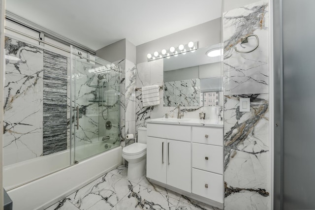 full bathroom with vanity, toilet, marble finish floor, and enclosed tub / shower combo