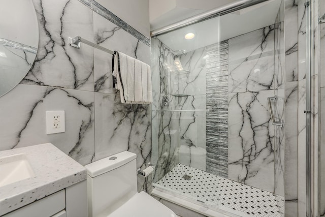 full bathroom with a marble finish shower, toilet, and vanity