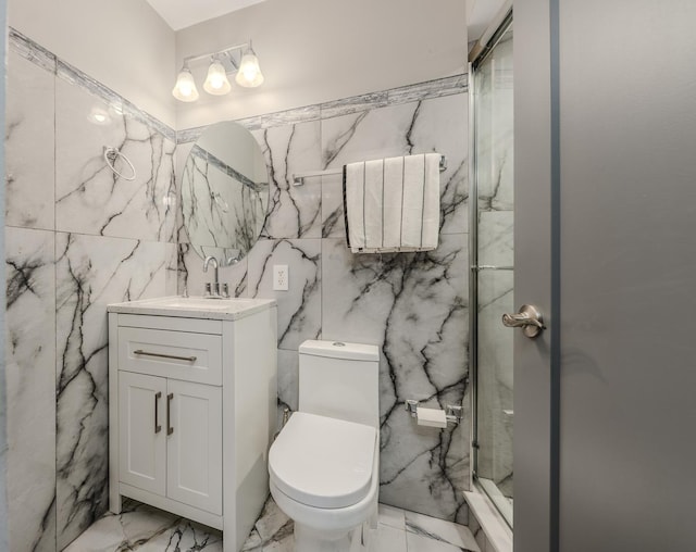 bathroom with a marble finish shower, toilet, vanity, and marble finish floor