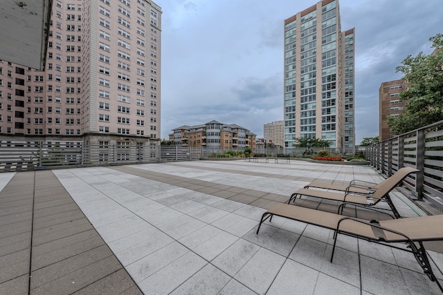 view of property's community with a view of city and a patio area