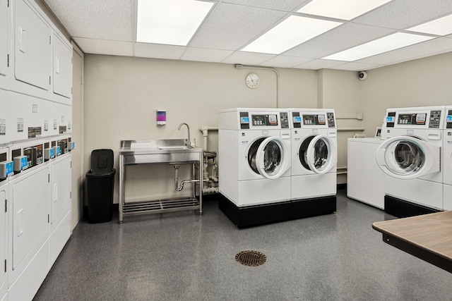 shared laundry area with a sink, stacked washing maching and dryer, and separate washer and dryer