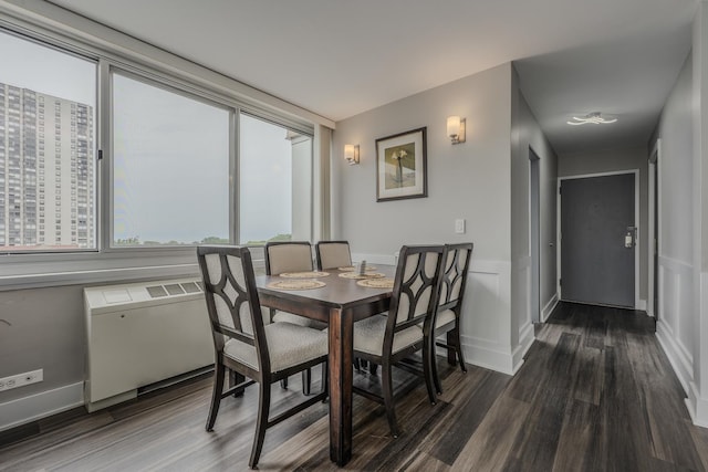 dining area with wainscoting and dark wood-style flooring