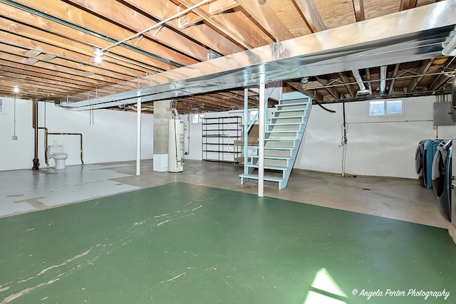 basement with electric panel, stairs, water heater, and washer and clothes dryer