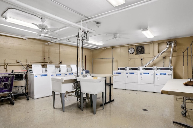 shared laundry area featuring a ceiling fan, separate washer and dryer, and concrete block wall