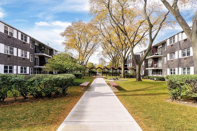 view of property's community featuring a yard and a residential view