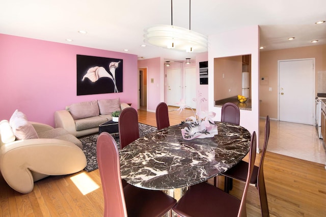 dining area with recessed lighting and light wood-style flooring