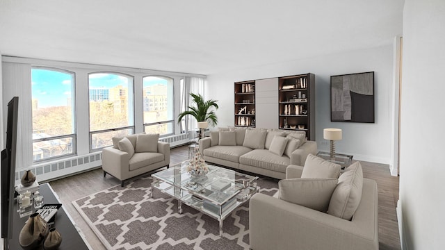 living area featuring radiator heating unit, wood finished floors, and baseboards