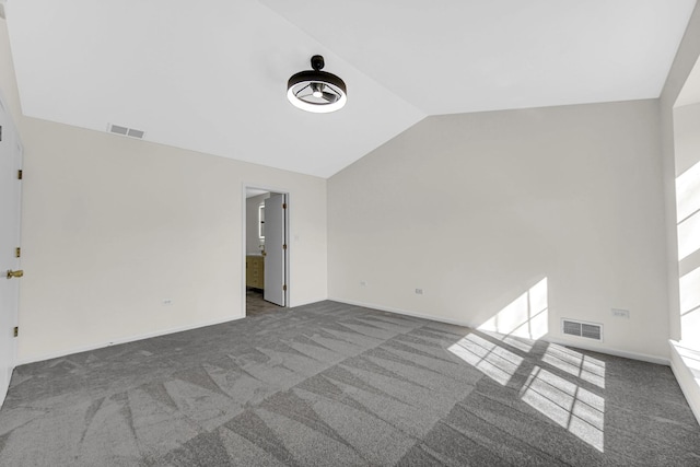 interior space featuring lofted ceiling, baseboards, and visible vents