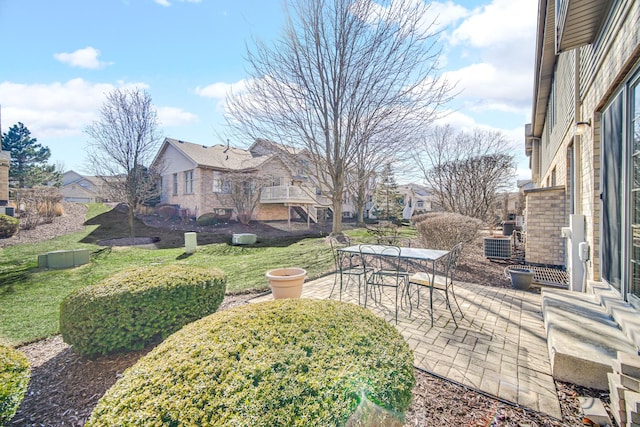 view of yard with outdoor dining area, a patio area, and a residential view