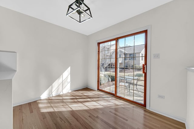 unfurnished room featuring wood finished floors and baseboards