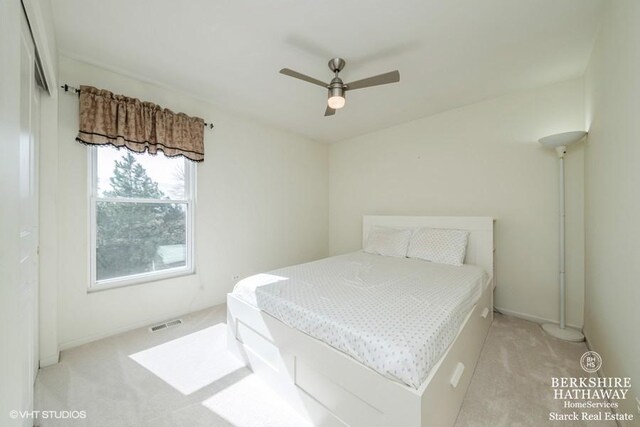 bedroom with carpet flooring, visible vents, and ceiling fan