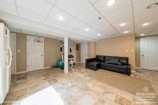 interior space featuring a drop ceiling, recessed lighting, and baseboards