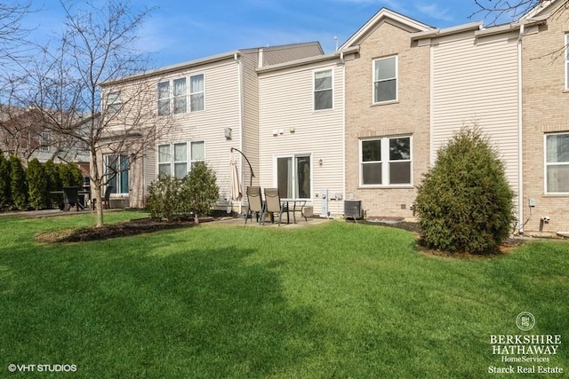 rear view of property with a patio area, central AC unit, brick siding, and a yard