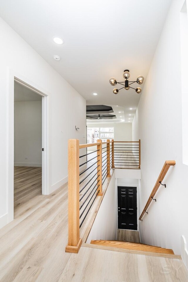 staircase featuring recessed lighting, baseboards, and wood finished floors