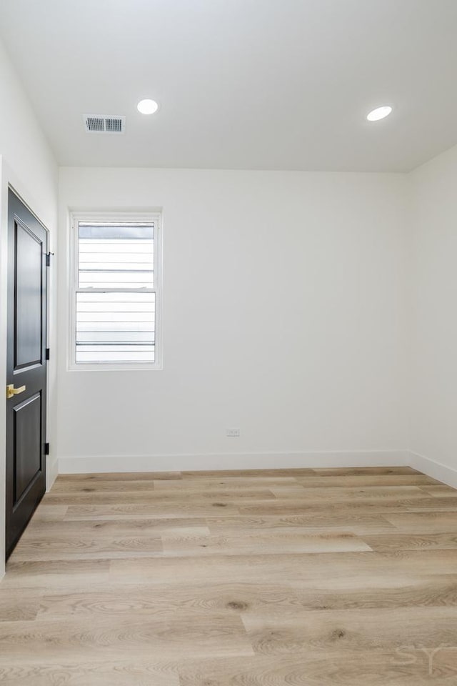 empty room featuring recessed lighting, baseboards, visible vents, and light wood finished floors