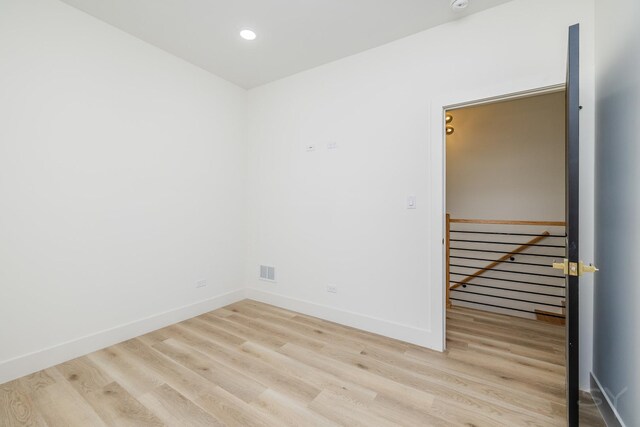 unfurnished room featuring recessed lighting, visible vents, baseboards, and wood finished floors