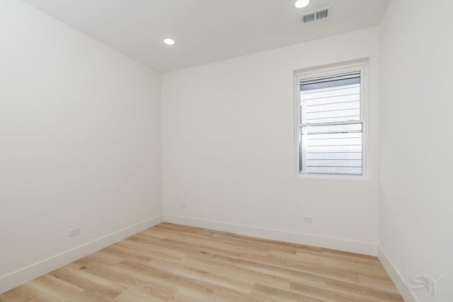 empty room featuring recessed lighting, light wood-type flooring, visible vents, and baseboards