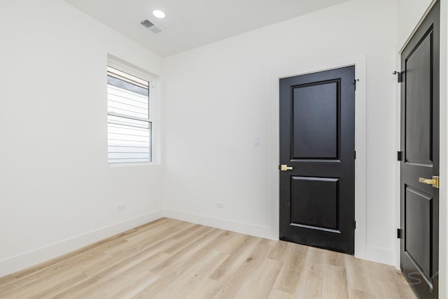 unfurnished room featuring recessed lighting, visible vents, baseboards, and wood finished floors