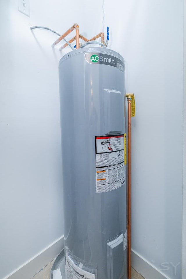 utility room with electric water heater