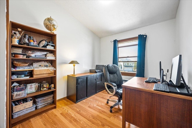 office area featuring lofted ceiling and light wood-style floors