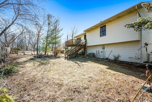 view of yard with cooling unit, a deck, and stairs