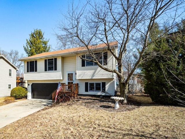 split foyer home featuring concrete driveway and an attached garage