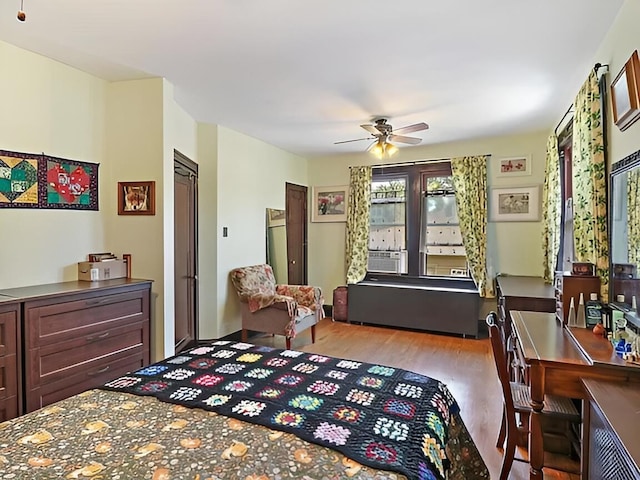 bedroom with a ceiling fan and wood finished floors