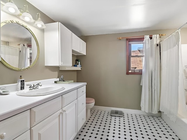 full bathroom featuring toilet, vanity, and baseboards