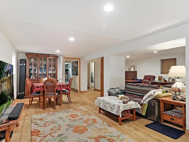 living area with recessed lighting and light wood-style flooring