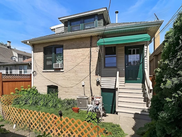 view of front of home with fence and brick siding