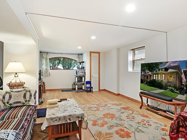 living area with recessed lighting, baseboards, and wood finished floors